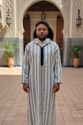 Man wearing a black and white striped hooded Moroccan thobe
