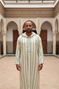Man wearing a cream and sage striped hooded Moroccan thobe