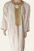 Ivory and gold embroidered Moroccan thobe on a clean background