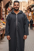 Man wearing a charcoal grey zip-front hooded Moroccan thobe