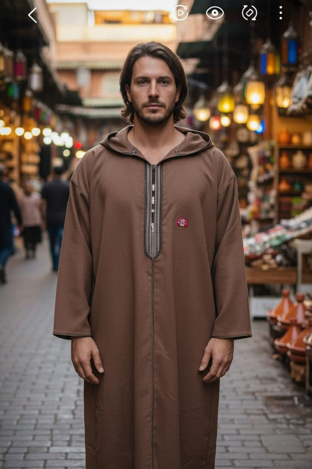 Man wearing a tan hooded Moroccan thobe
